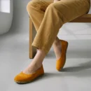 Person wearing yellow barefoot flats, corduroy pants