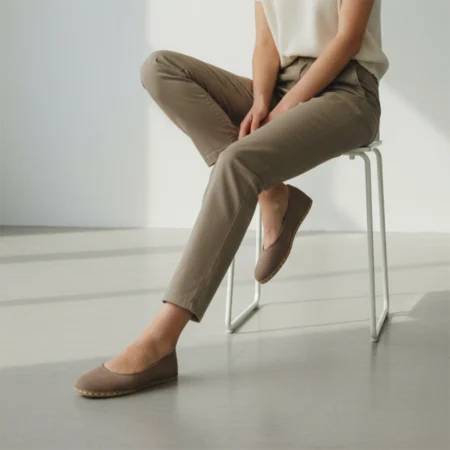 Barefoot flats shoes. Woman sitting in casual outfit.